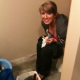 A guy breaks into the bathroom to videotape his girlfriend peeing on the toilet while eating some cotton candy.